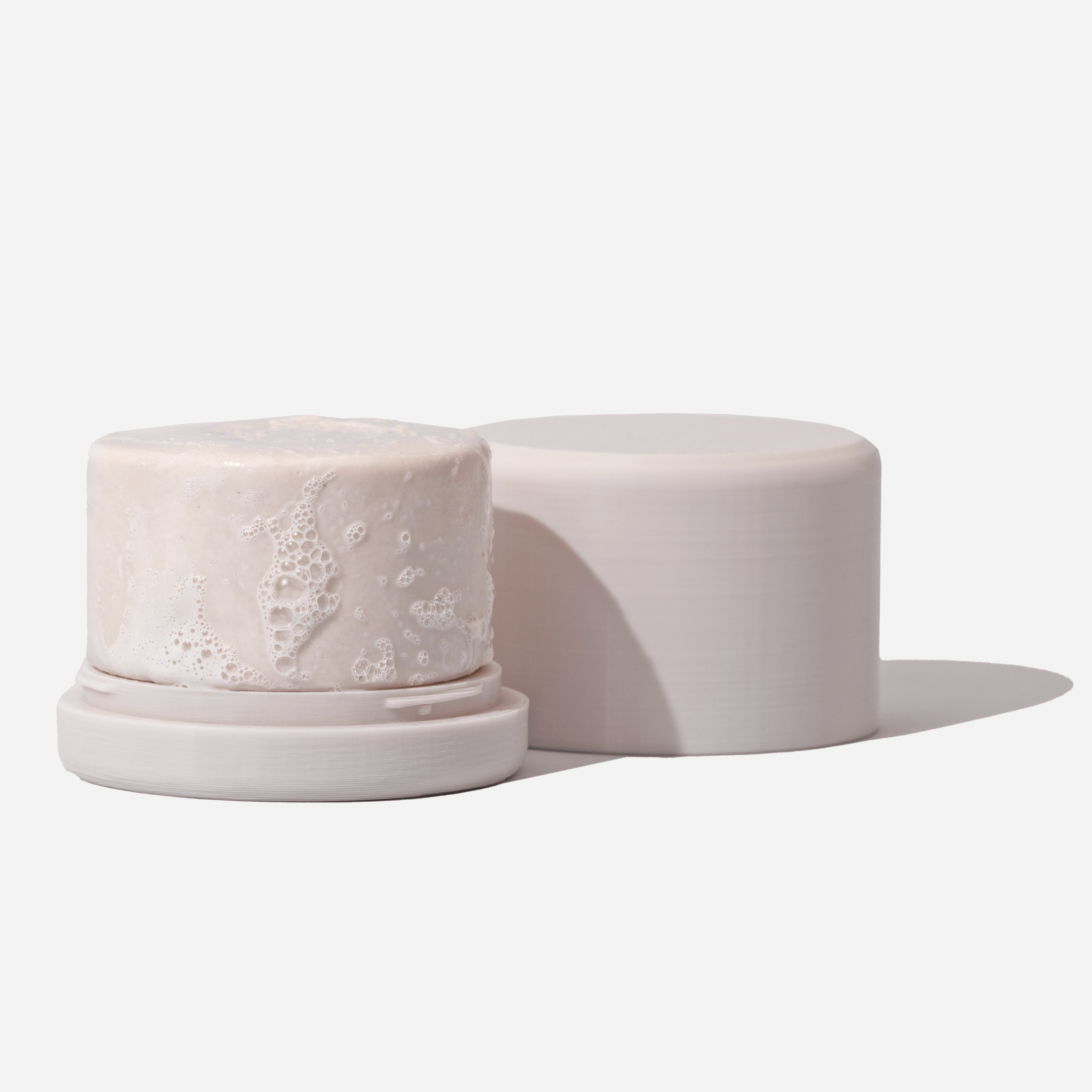 Eco-friendly shampoo bar holder with a solid shampoo. Perfect for travel. 100% recycled plastic