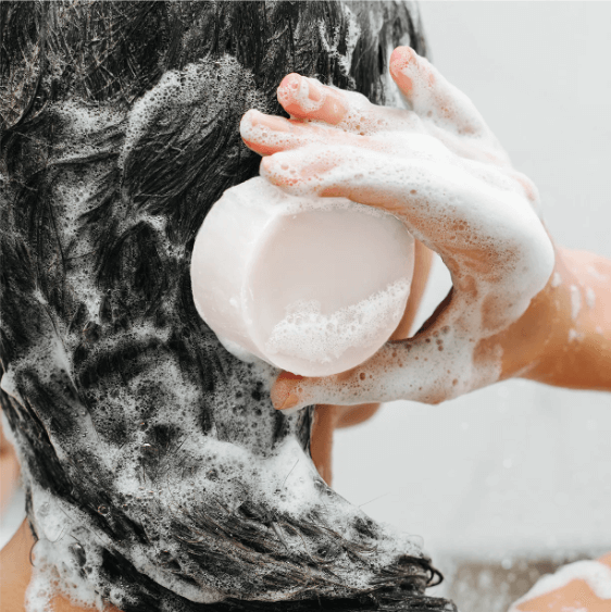Using a solid shampoo bar for eco-friendly, organic hair care with abundant foam for all hair types.